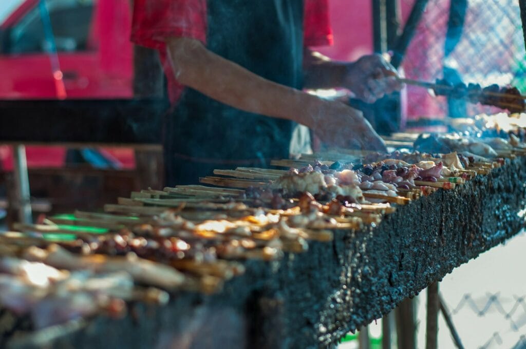 grilling satay or kebabs at the stall