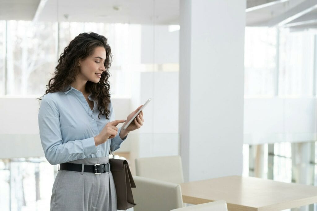 Young elegant female chief executive officer of modern high tech company